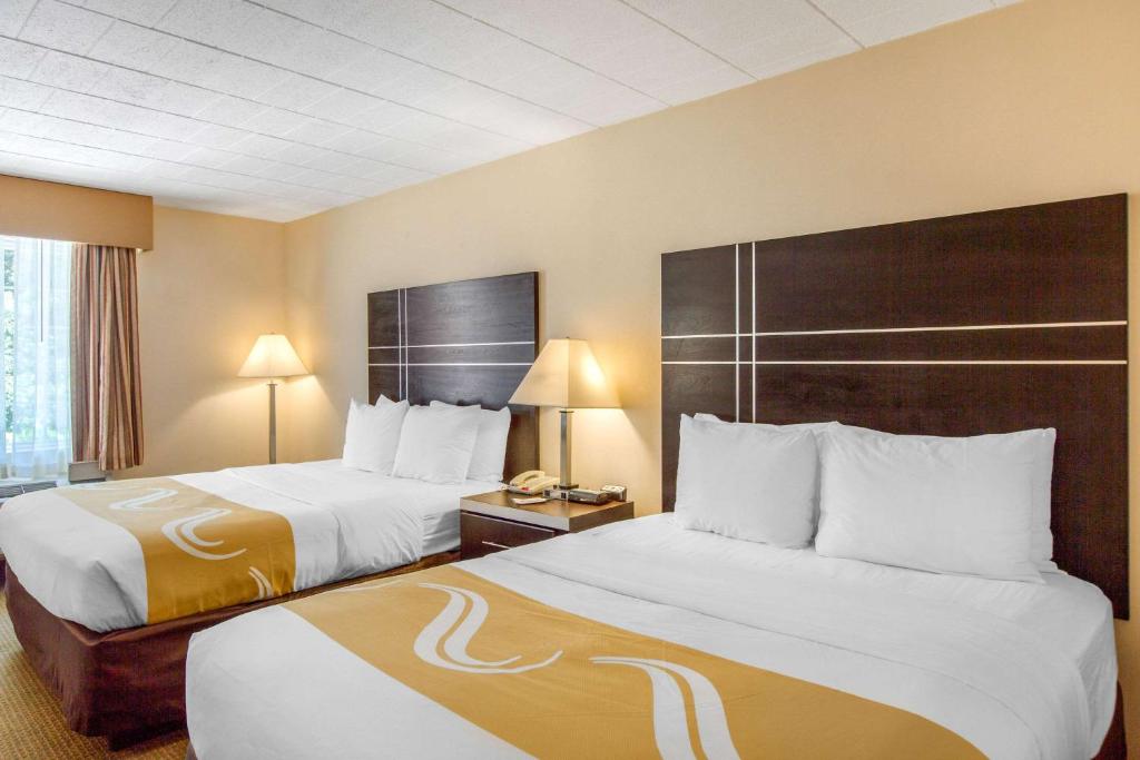 a hotel room with two beds and two lamps at Quality Inn Ledgewood - Dover in Ledgewood