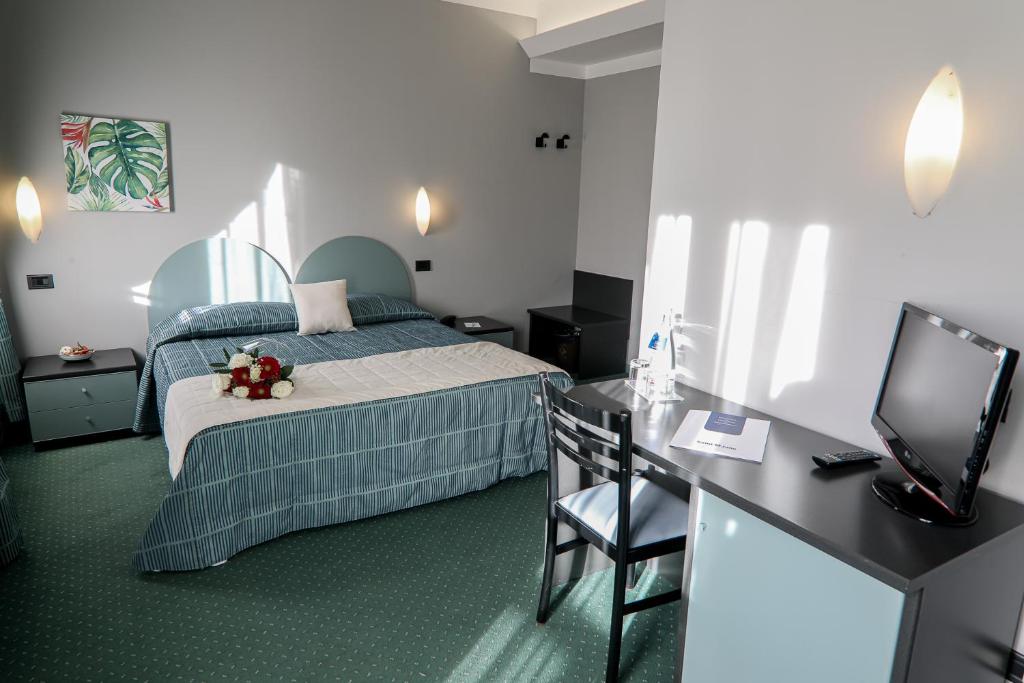 Postel nebo postele na pokoji v ubytování Hotel Vittoria