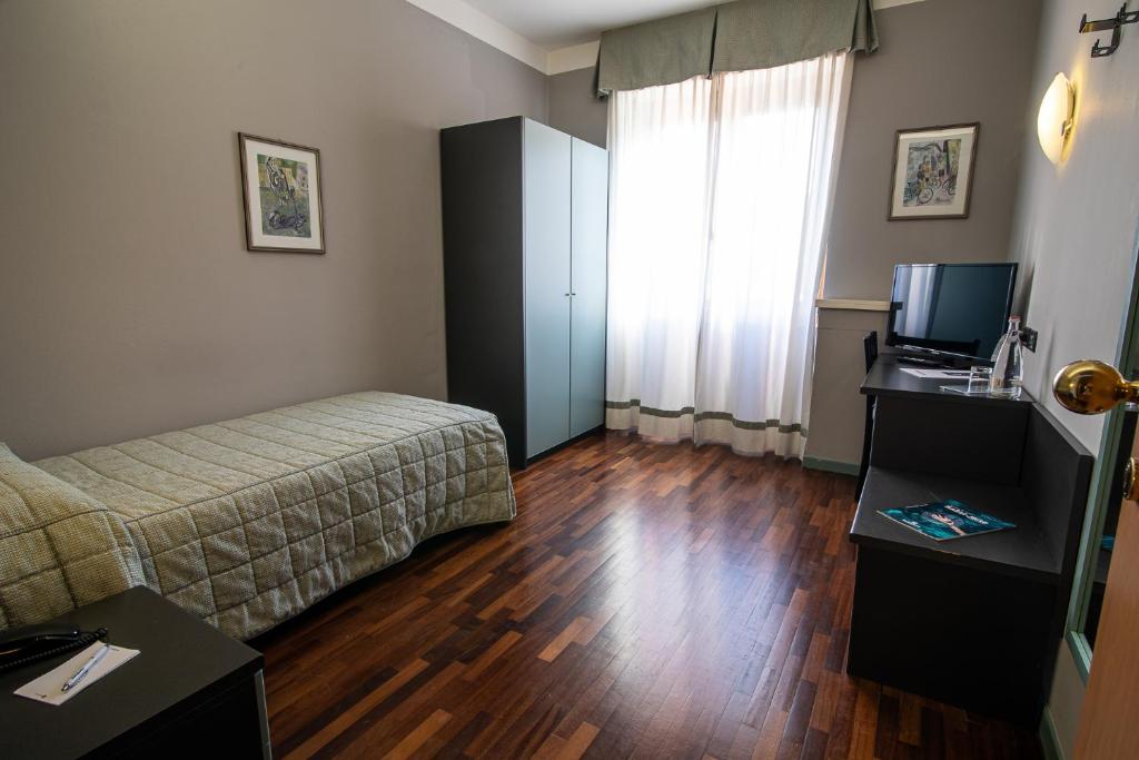 Postel nebo postele na pokoji v ubytování Hotel Vittoria