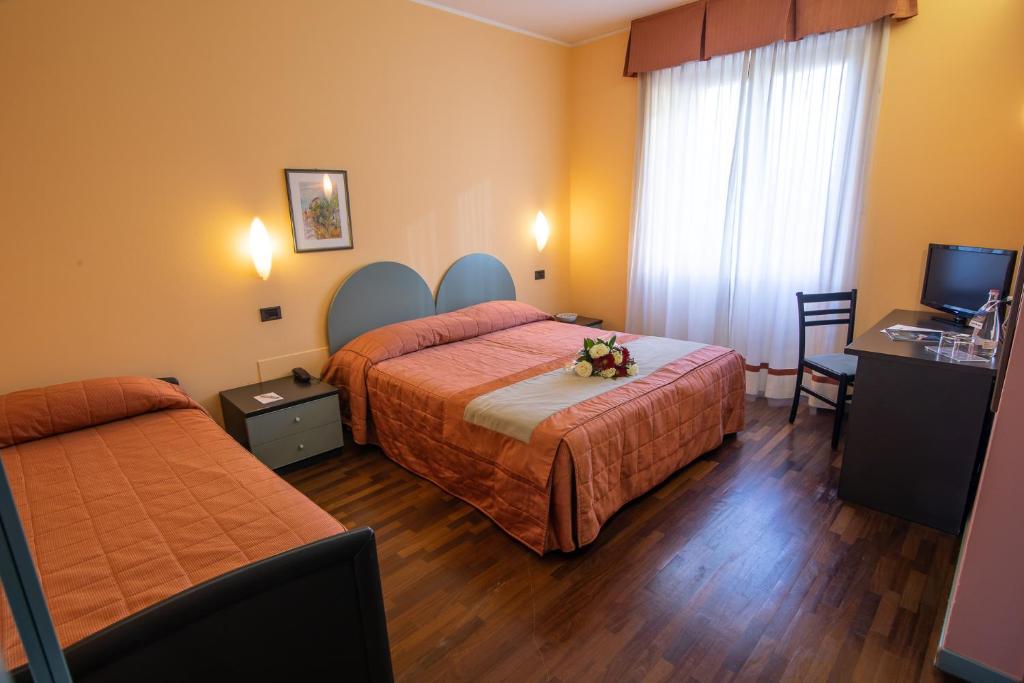 Postel nebo postele na pokoji v ubytování Hotel Vittoria