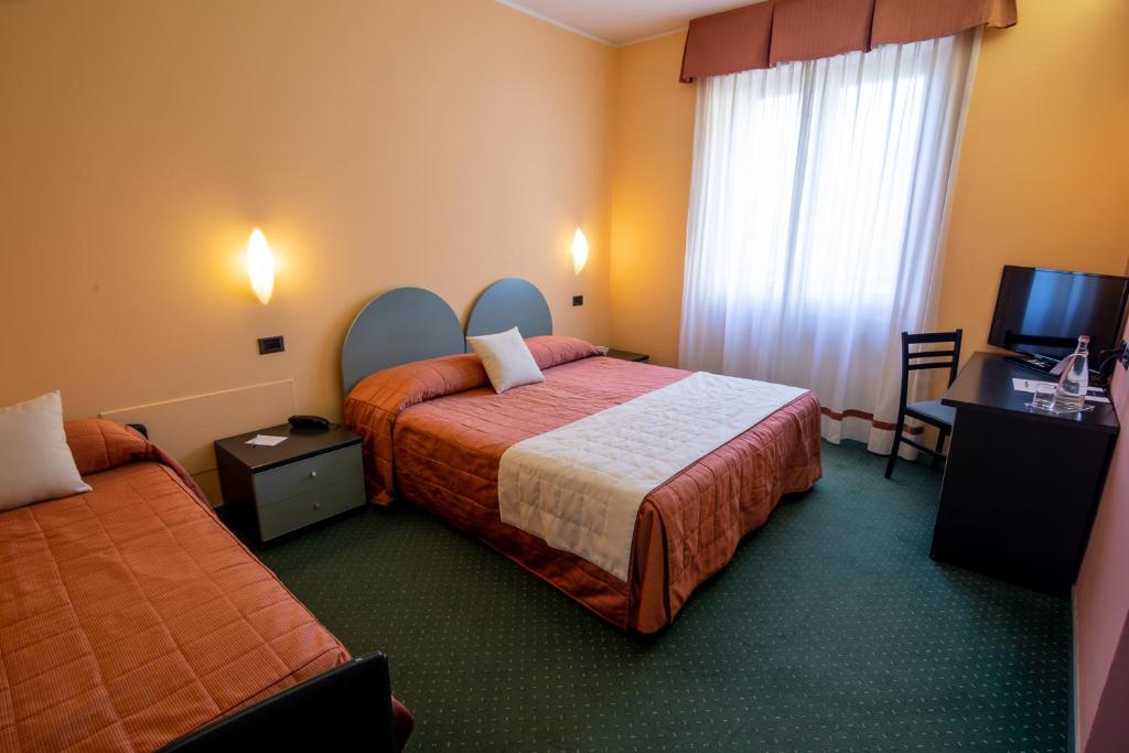 Postel nebo postele na pokoji v ubytování Hotel Vittoria