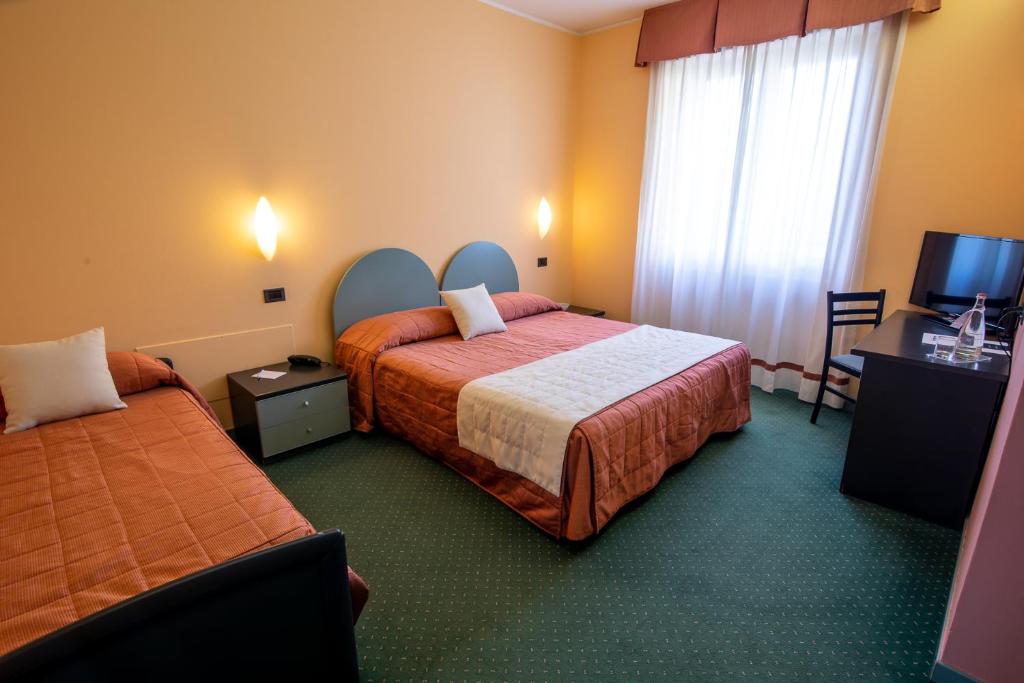 Postel nebo postele na pokoji v ubytování Hotel Vittoria