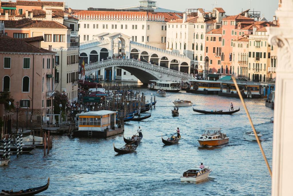 a group of boats in a river with a bridge at Palazzo Barocci in Venice