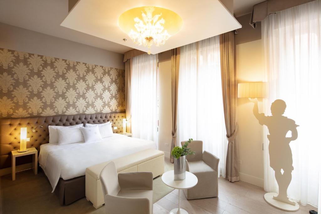 a hotel room with a bed and a window at Palazzo Barocci in Venice