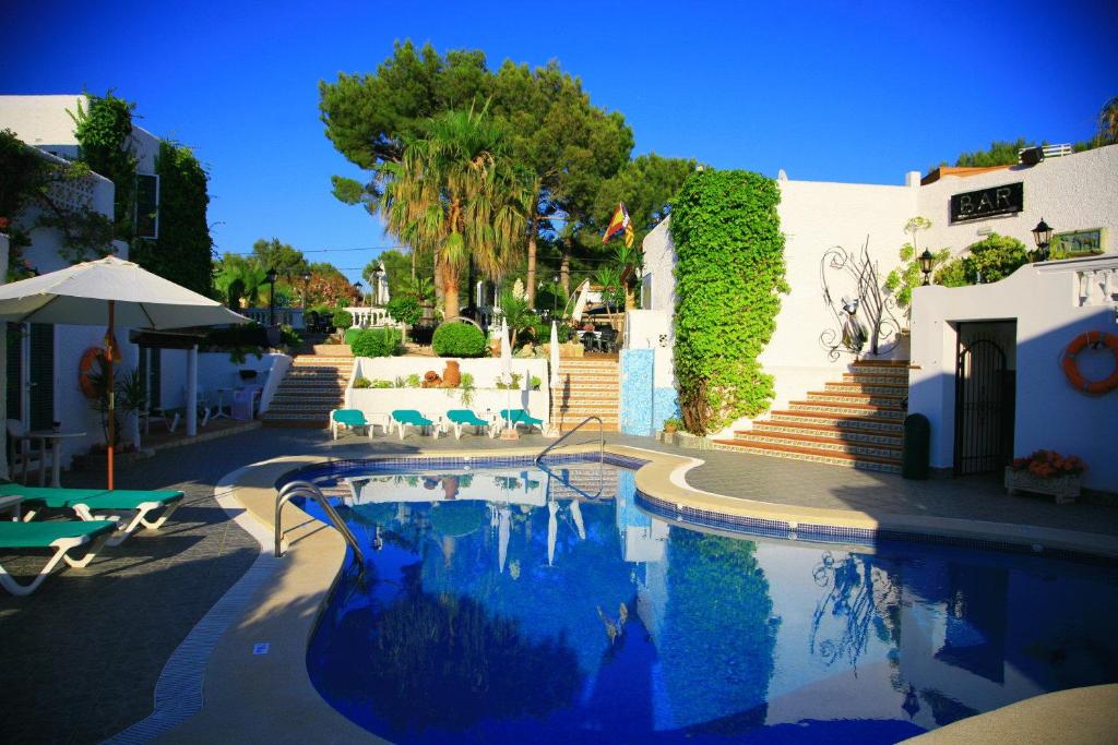 a white swimming pool with a blue sky at Villa Columbus Family Boutique Hotel in Paguera