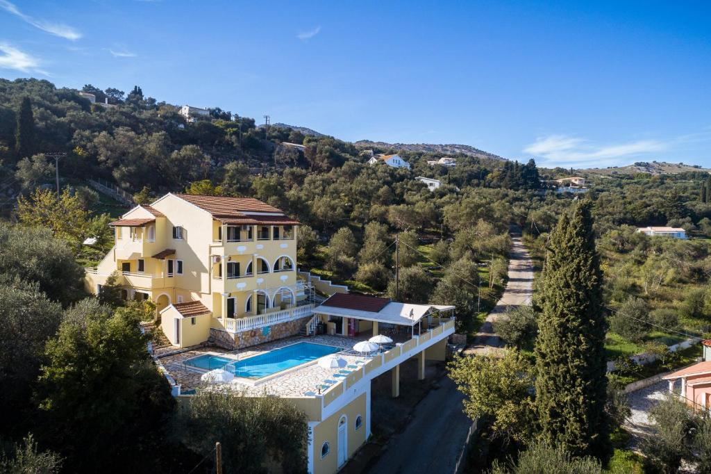 an aerial view of a house with a swimming pool at Apollon Apartments in Kassiopi
