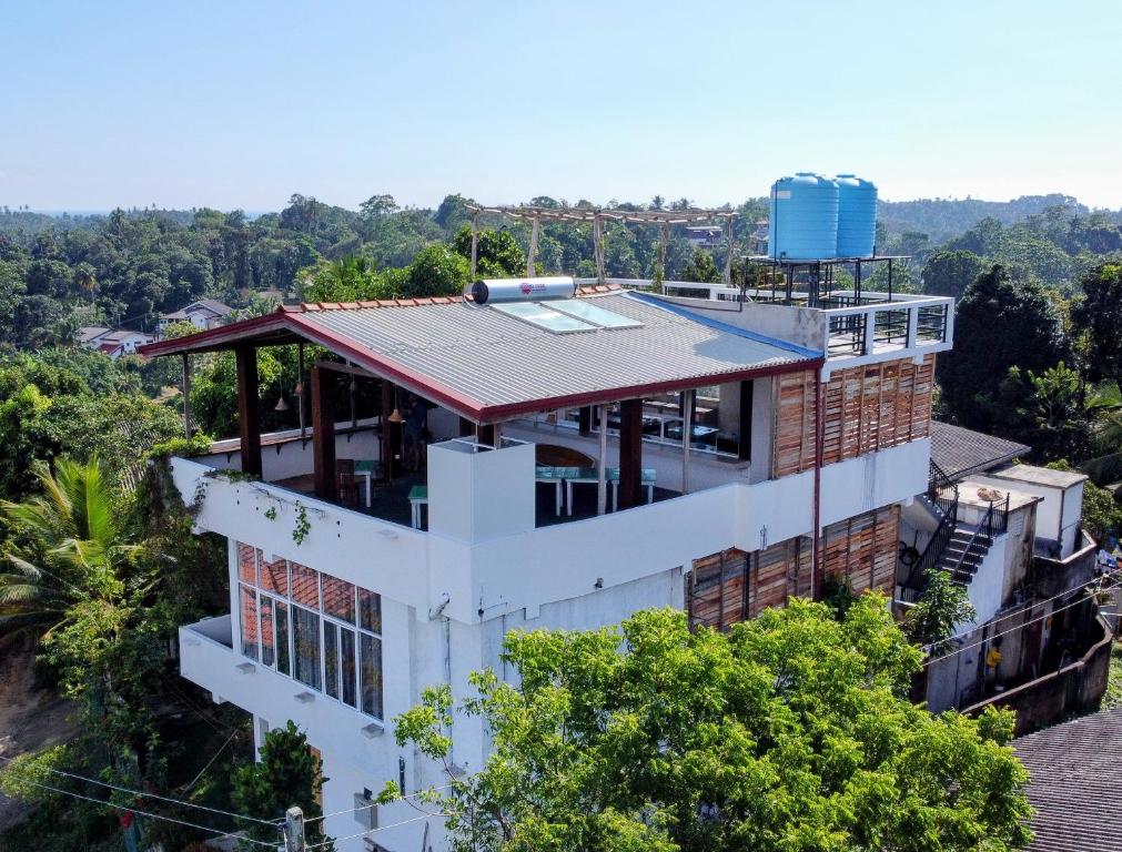 an overhead view of a building with a roof at Namal Stay in Weligama