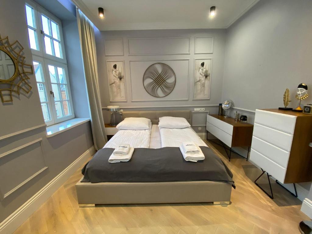 a bedroom with a bed and a dresser at Maya's Flats & Resorts 44 - 3 rooms apartment on Chlebnicka Street Gdańsk Old Town in Gdańsk