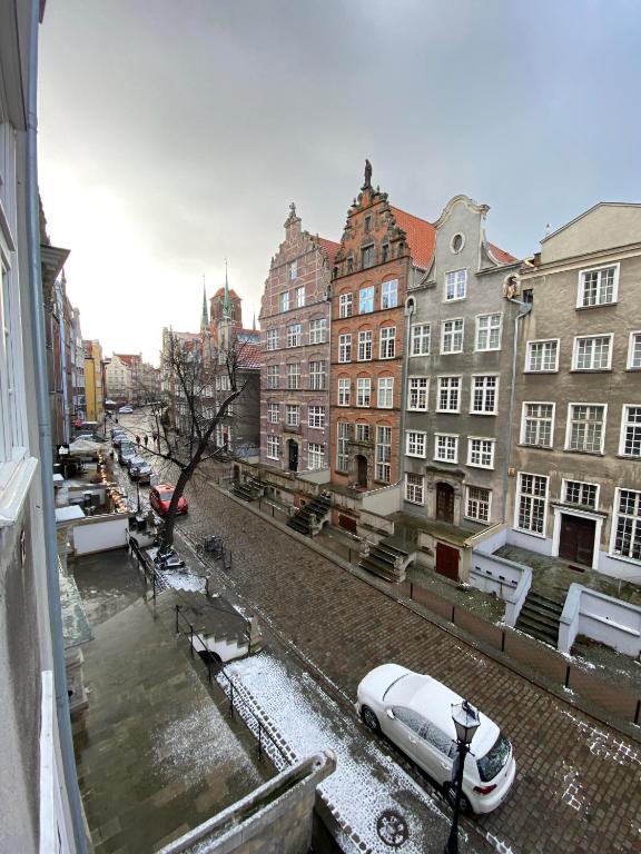 a view of a street with buildings and a car at Maya's Flats & Resorts 44 - 3 rooms apartment on Chlebnicka Street Gdańsk Old Town in Gdańsk