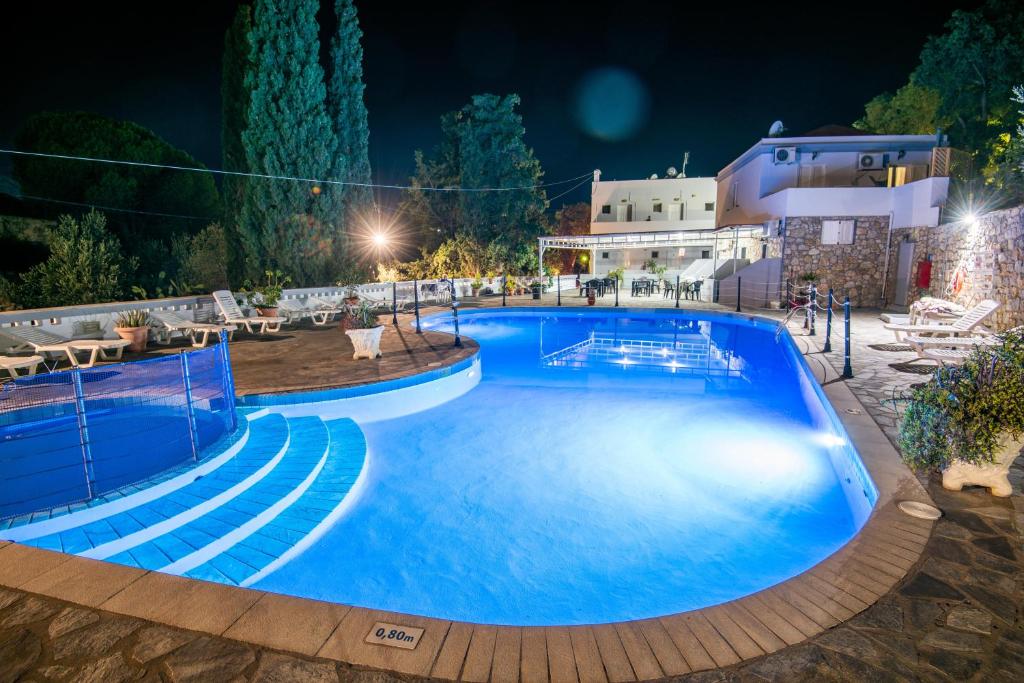 a large swimming pool at night at Ilias Studios sevasti in Panormos Kalymnos