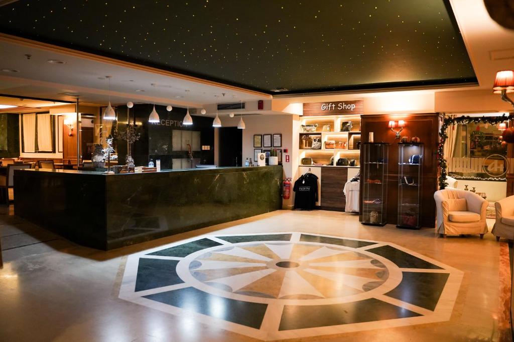 a lobby with a bar and a counter with a room at Hotel Antoniadis in Kalabaka