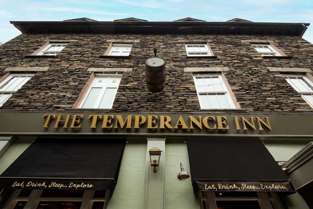 a tall building with a sign that reads the temperature inn at The Temperance Inn - The Inn Collection Group in Ambleside