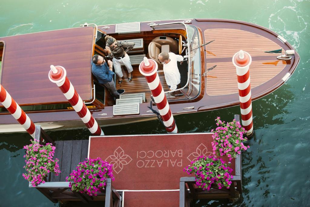 a group of people on a boat in the water at Palazzo Barocci in Venice