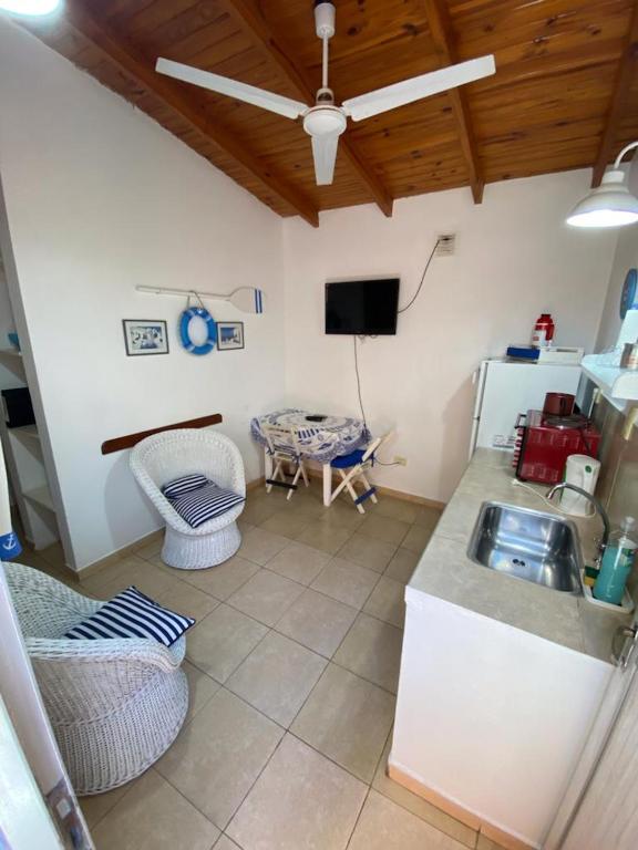 a kitchen with a sink and a table and a tv at Espacio Mar in Posadas