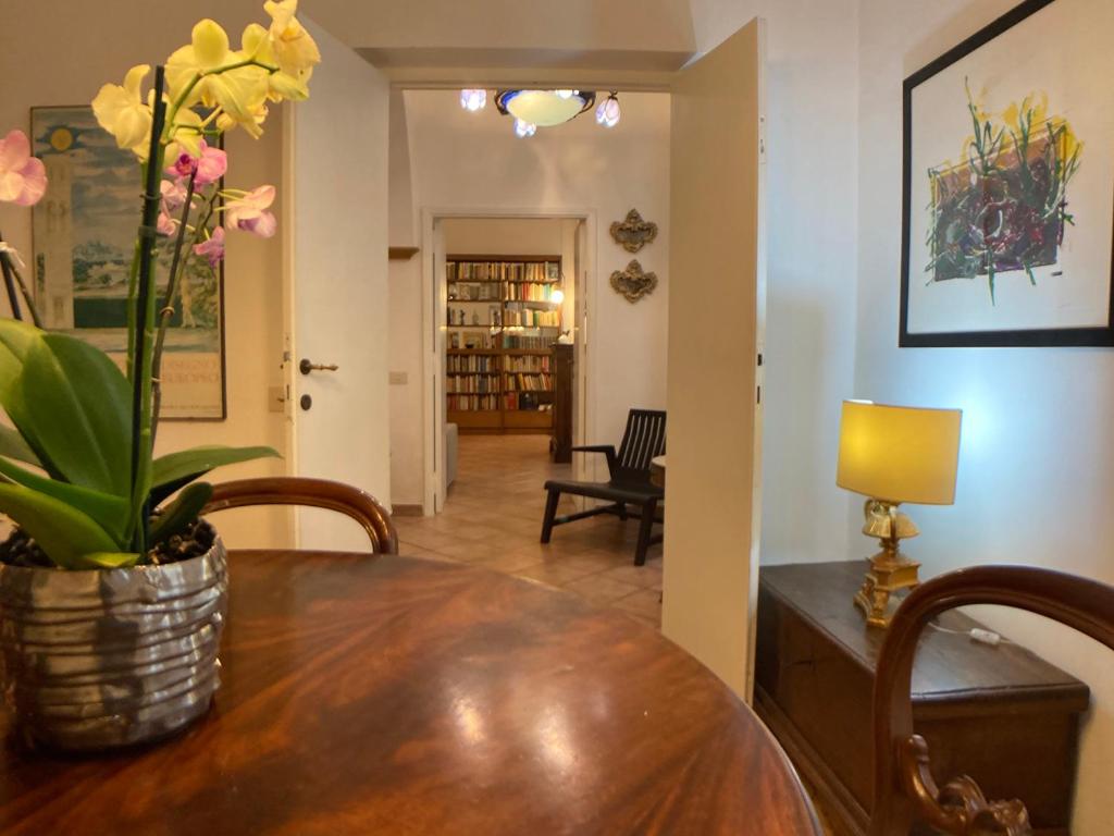 a dining room with a table with a potted plant on it at Maison Vivalda In Piazza Navona in Rome