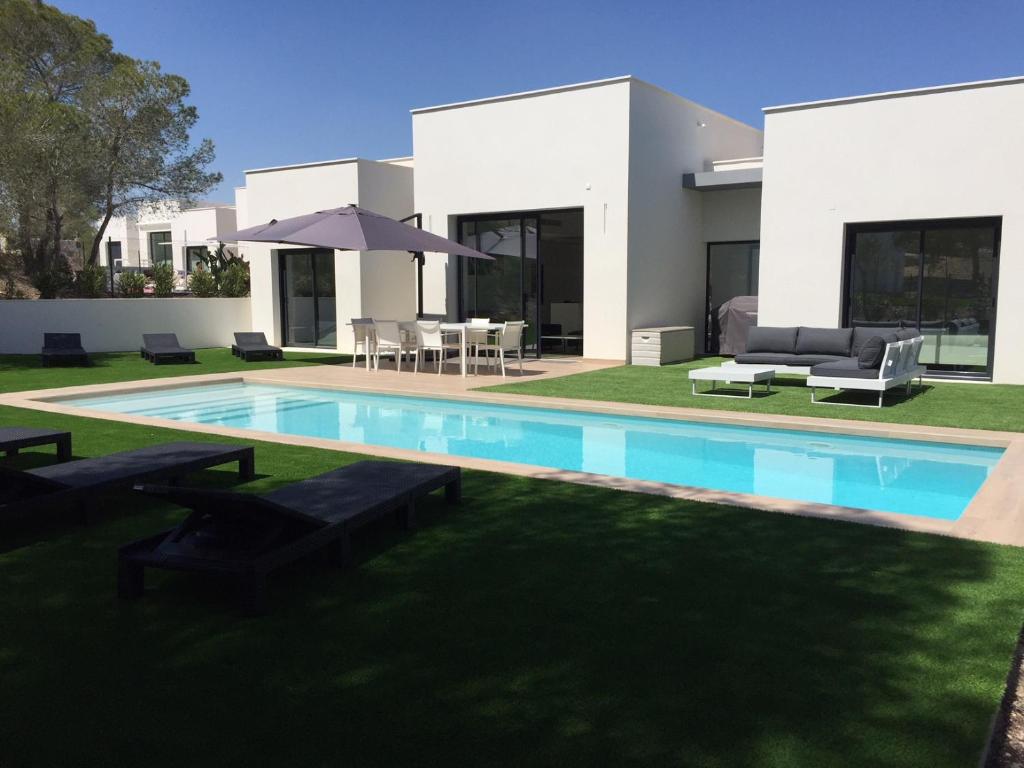 a house with a swimming pool in the yard at Villa Acacia in Orihuela Costa