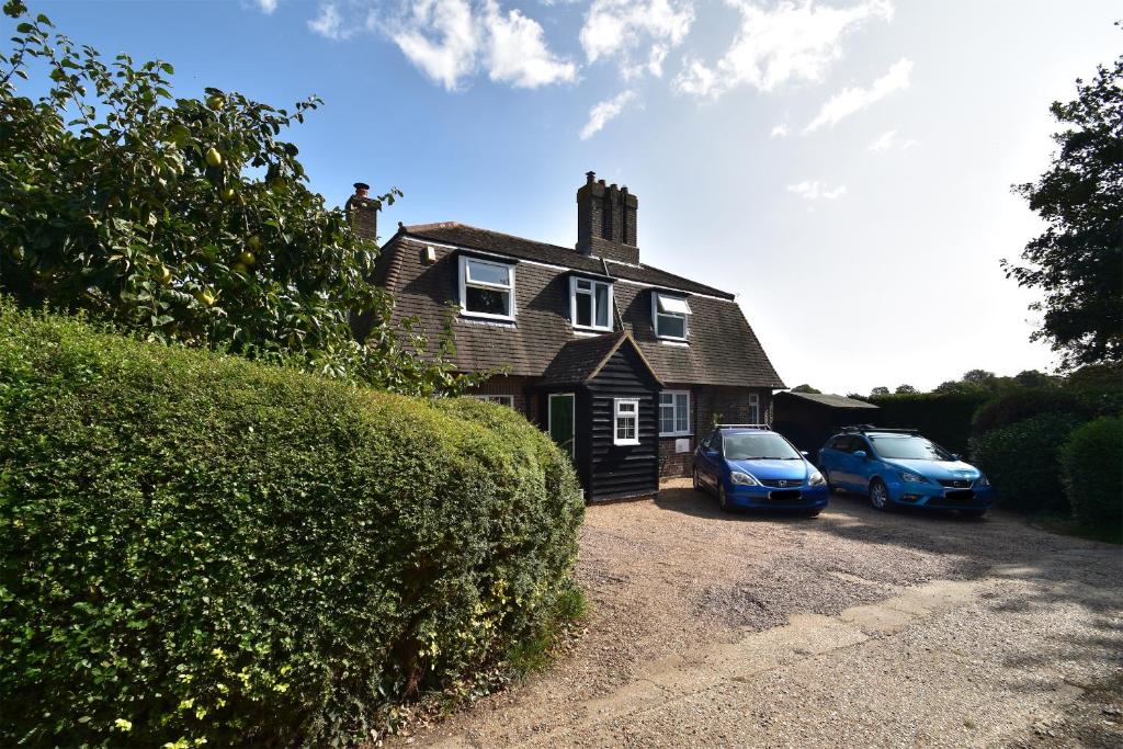 a house with two cars parked in front of it at Maytham Cottage in Rye