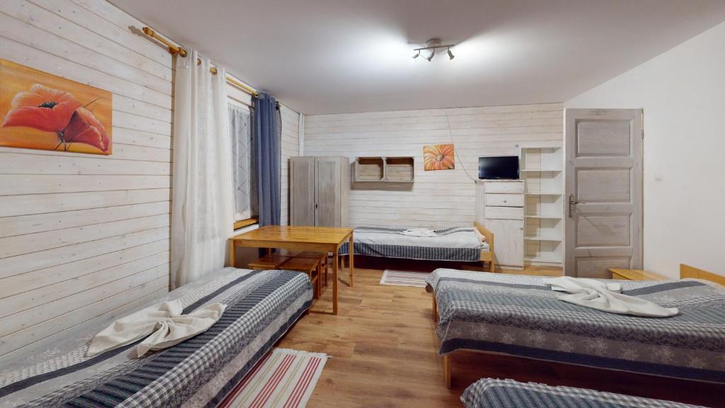 מיטה או מיטות בחדר ב-Agroturystyka Marzena