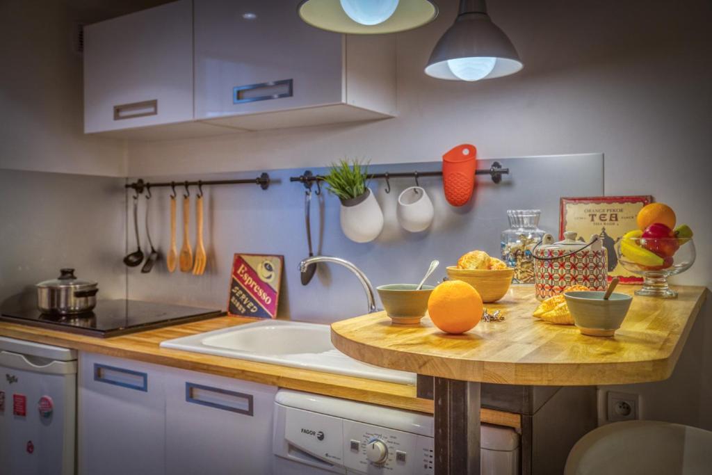 a kitchen with a counter with fruits and vegetables on it at Charmant petit duplex _ 24m2 in La Tronche