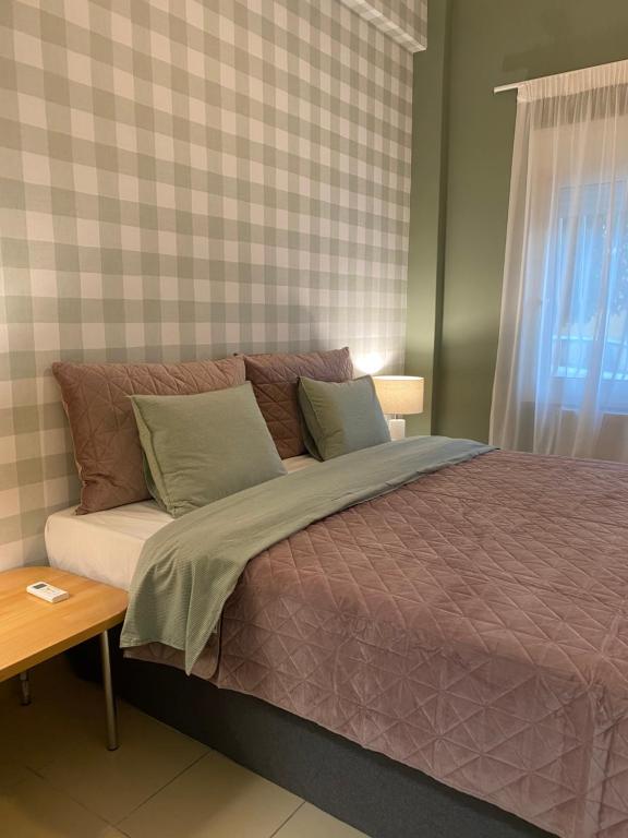 Säng eller sängar i ett rum på CASA MILITOU-NEA FILADELFIA