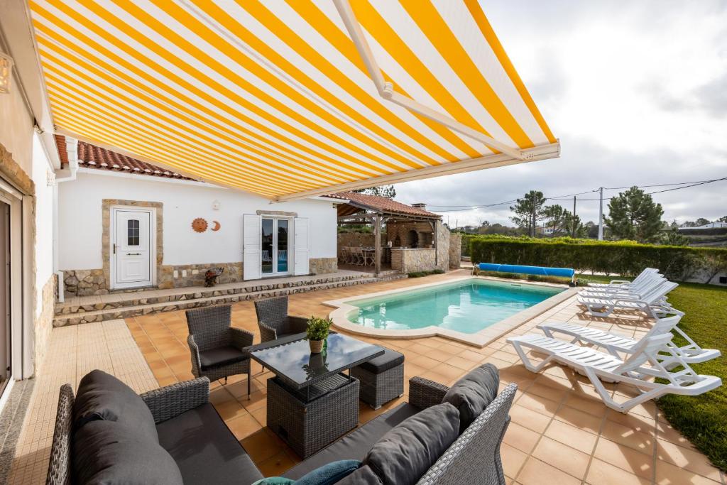 アルジェズールにあるCasa dos Sonhadoresのパティオ(プール、椅子、パラソル付)