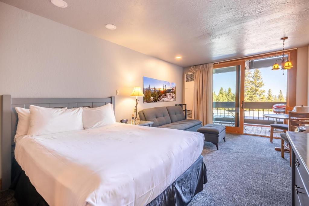 a bedroom with a large bed and a living room at Hotel Style Room in The Timber Creek Lodge condo in Truckee