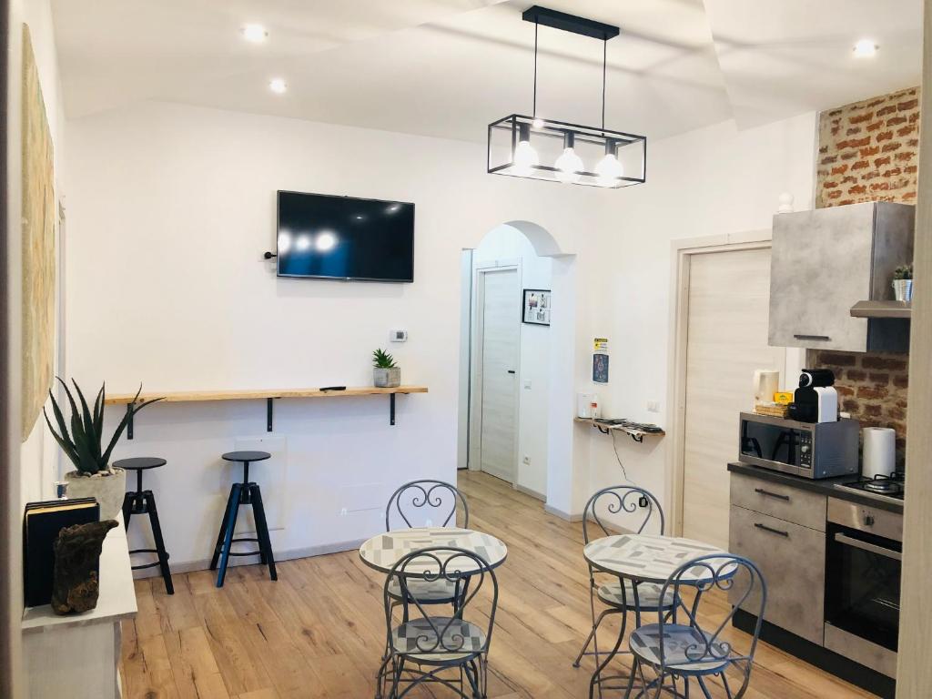 a kitchen with two tables and chairs in a room at Rial Maison in Bergamo