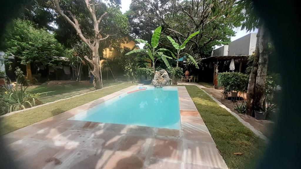 a swimming pool in the backyard of a house at Chale Kangaroos Imbassai in Imbassai