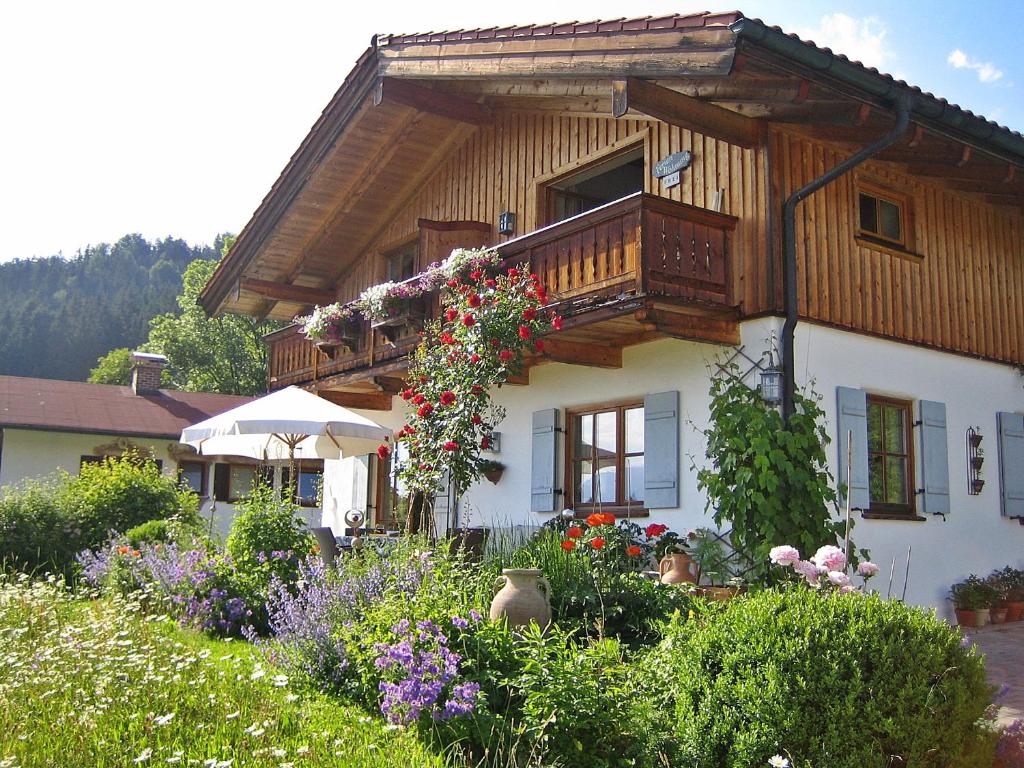 a house with a balcony with flowers on it at Haus Klauser in Reit im Winkl
