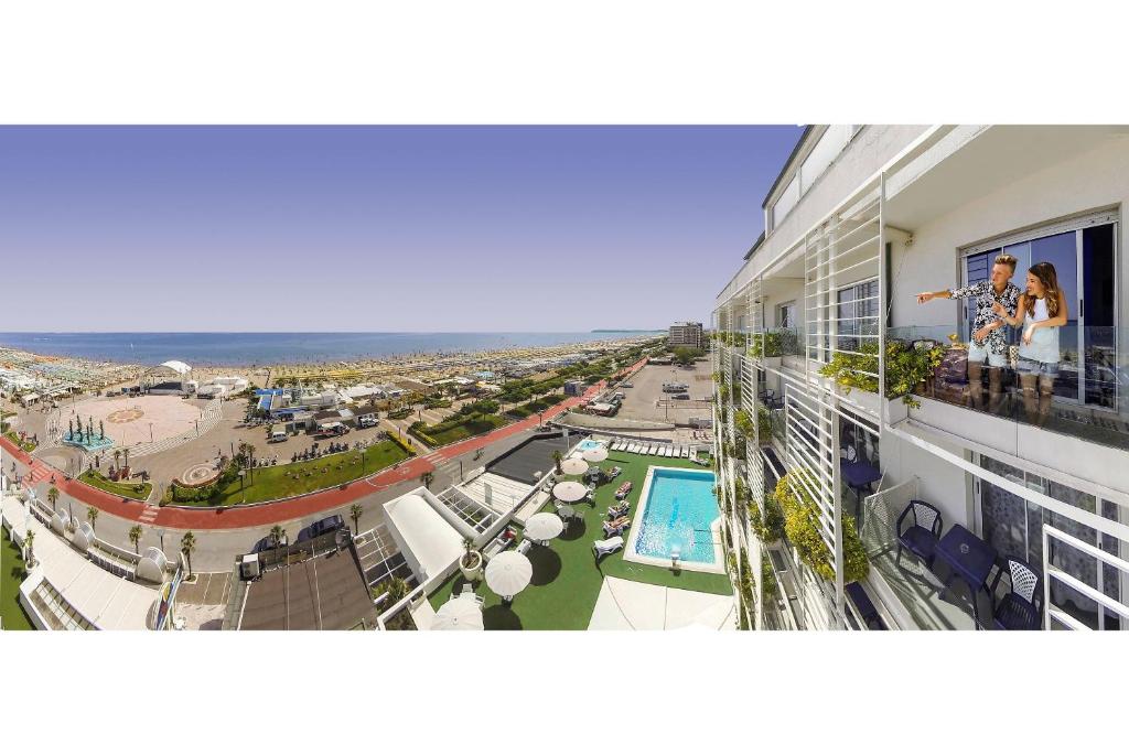 a view of a building with a pool and a beach at Hotel Mediterraneo in Riccione