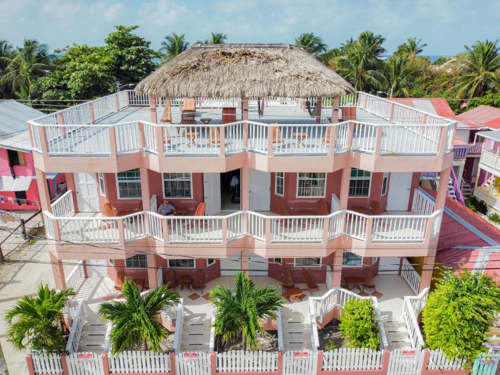 an aerial view of a pink house with a large balcony at Caye Caulker Condos in Caye Caulker