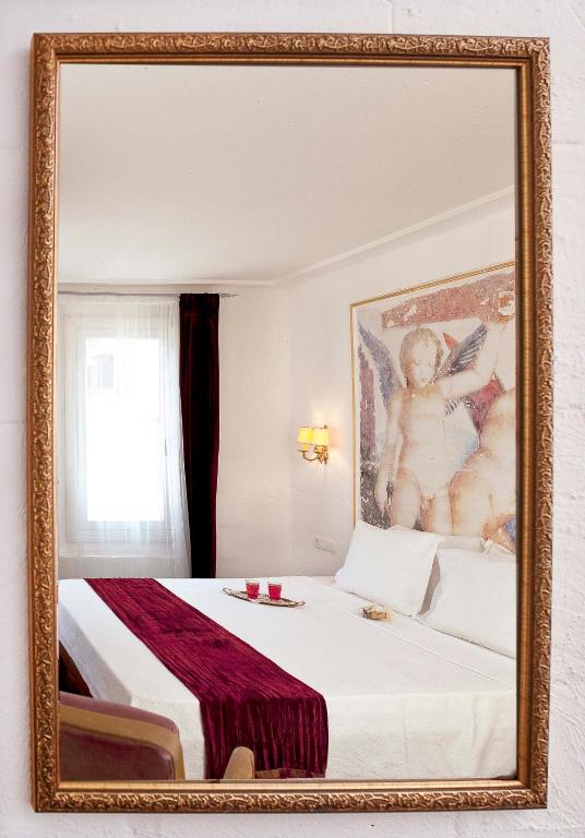 A bed or beds in a room at Moshinos Hotel