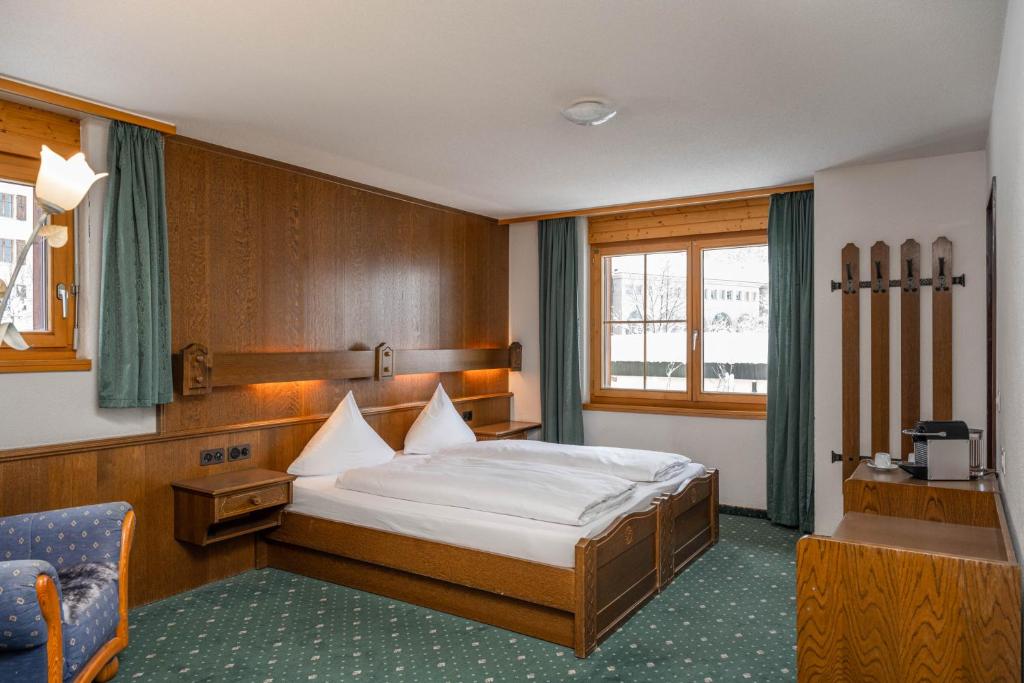 Postel nebo postele na pokoji v ubytování Grichting Hotel & Serviced Apartments