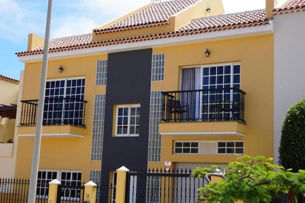 a yellow and black house with a black balcony at Casa Totalmente Renovada en Zona muy Tranquila!!! Vistas al Mar y Montaña in Buenavista del Norte
