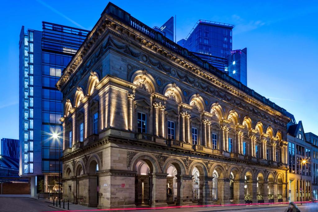 an old building in a city at night at The Edwardian Manchester, A Radisson Collection Hotel in Manchester