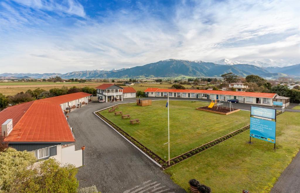 an aerial view of a building with mountains in the background at Kaikoura Motor Inn in Kaikoura