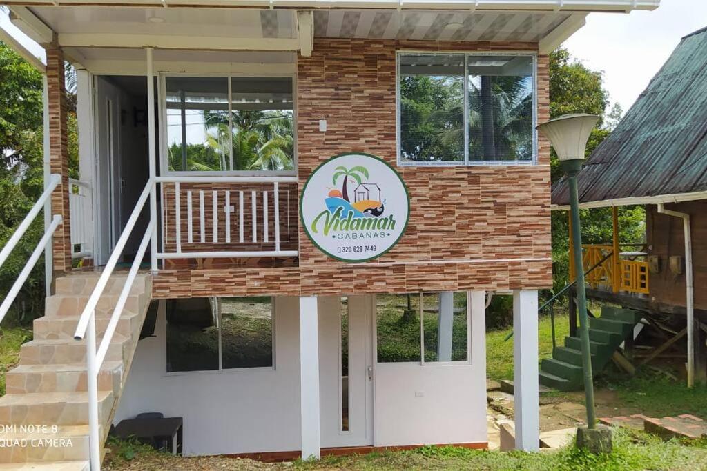 a house with a sign on the front of it at VIDAMAR, JUANCHACO. LADRILLEROS, LA BARRA in Playa Ladrilleros