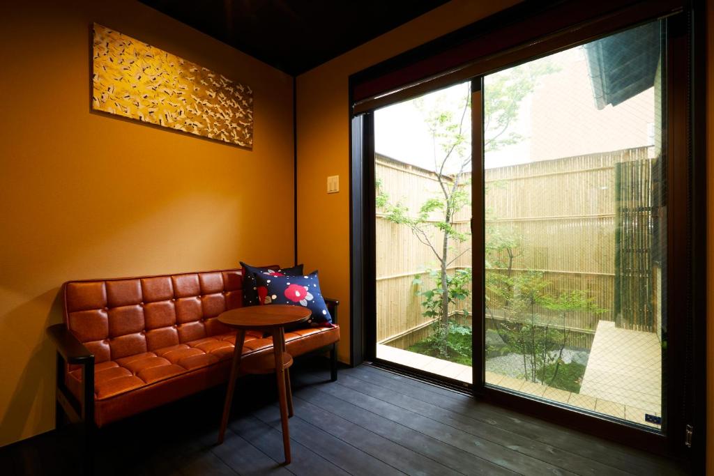 a living room with a couch and a large window at Rinn Fushimiinari in Kyoto