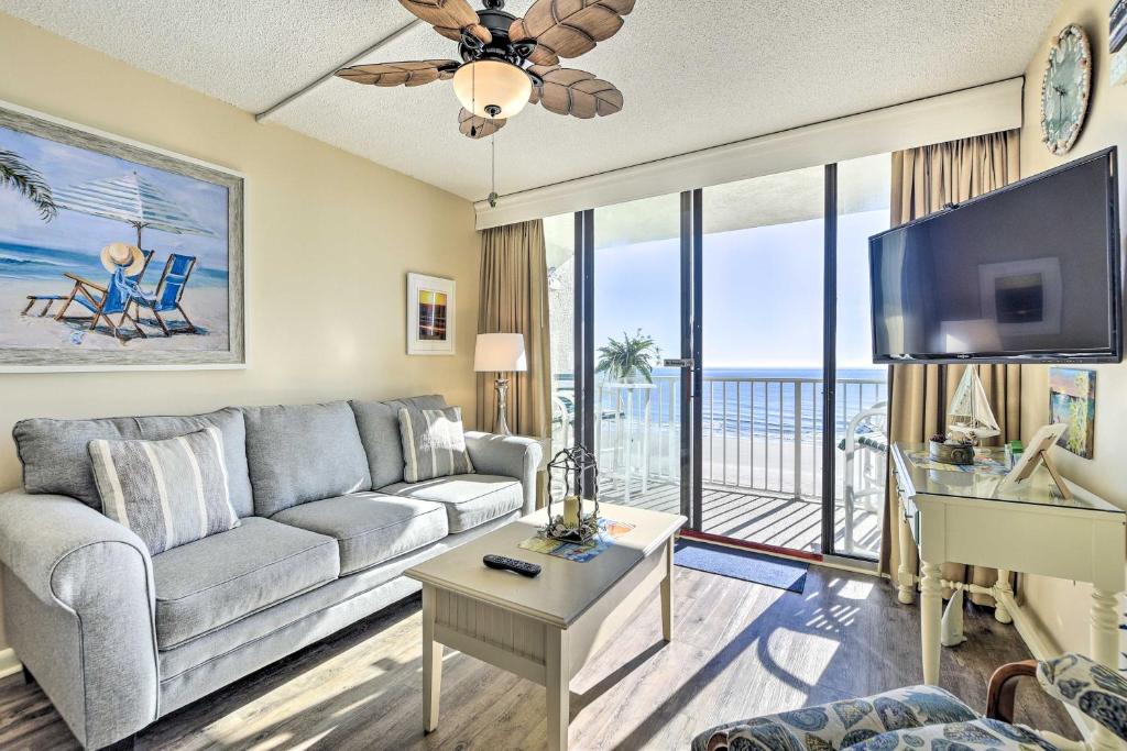 a living room with a couch and a tv at Dreamy Beach Condo with Views and Amenity Access! in Myrtle Beach