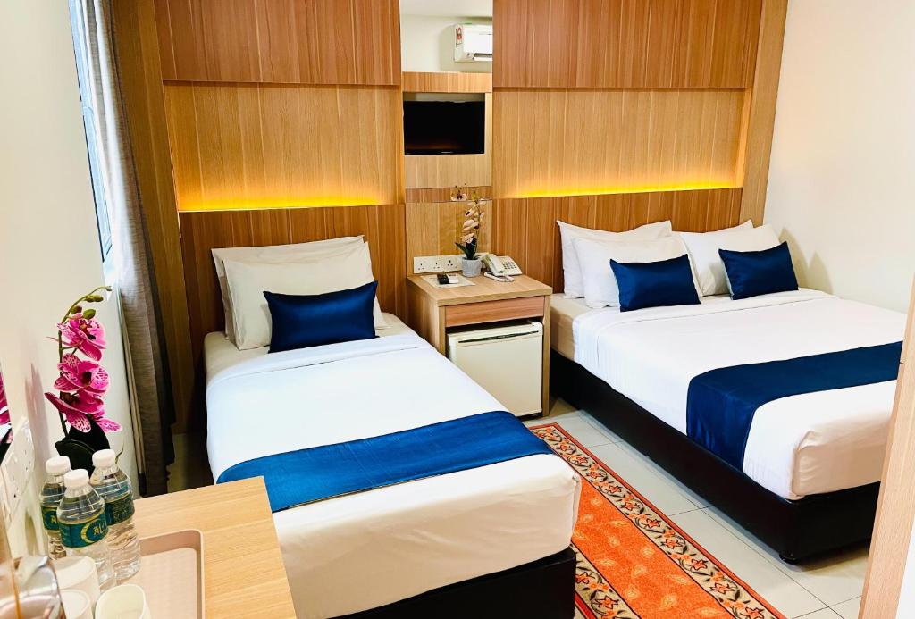 Postel nebo postele na pokoji v ubytování ESSY Hotel KL Sentral