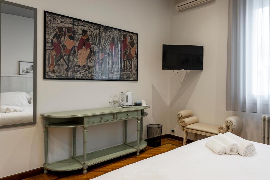 Postel nebo postele na pokoji v ubytování Seven Suites Pieve