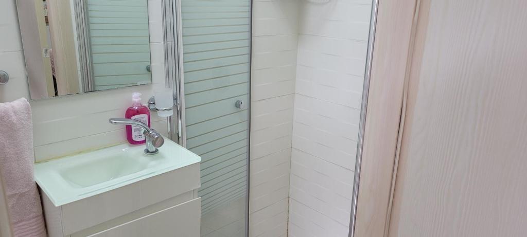 a bathroom with a sink and a shower at Neviot in Eilat