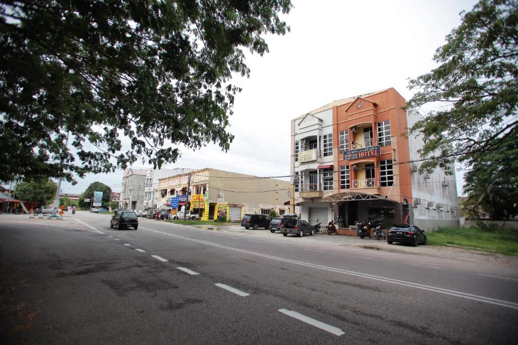 a city street with cars driving down the street at KB MYPLACE in Kota Bharu