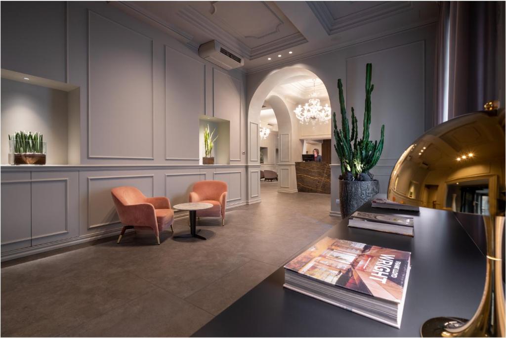 a lobby with chairs and a table in a room at WorldHotel Casati 18 in Milan