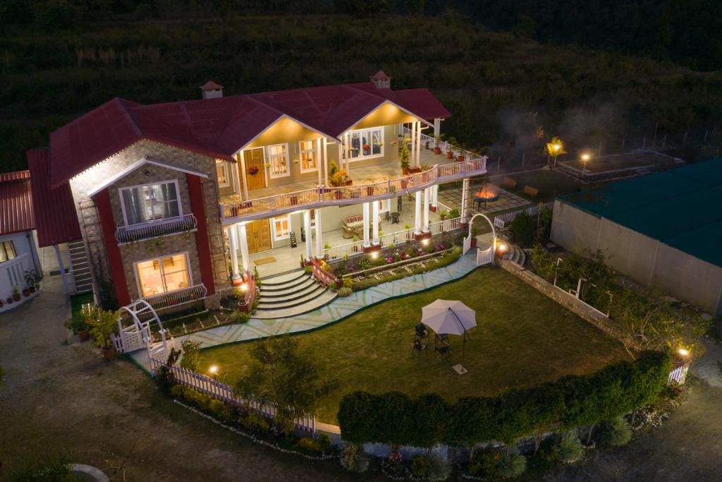 an overhead view of a large house with an umbrella at StayVista at SilverOaks Cottage in Dehradun