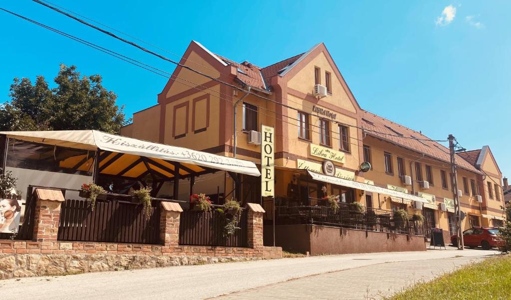 a building on the side of a street at Libra Hotel in Veresegyház