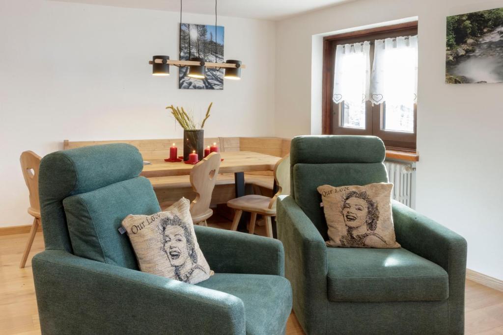 a living room with two chairs and a table at HelloChalet - Maison Mont Fleury- newly refurbished 50 mt center and ski bus stop in Valtournenche