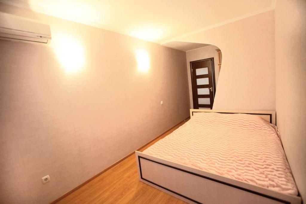 ein kleines Schlafzimmer mit einem Bett und einer Leiter in der Unterkunft Двухкомнатная квартира 300м от моря ул Парковая 18 отчетные док in Tschornomorsk
