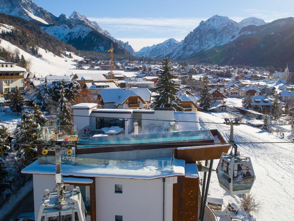 a view of a ski resort in the snow at Al Plan Hotel Oldtimer Dolomites in San Vigilio Di Marebbe