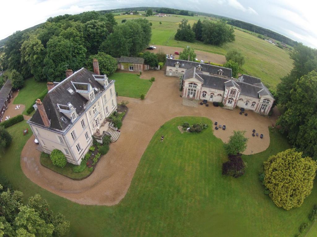 an aerial view of a large house on a green field at Domaine de Bel Air in Cérans-Foulletourte